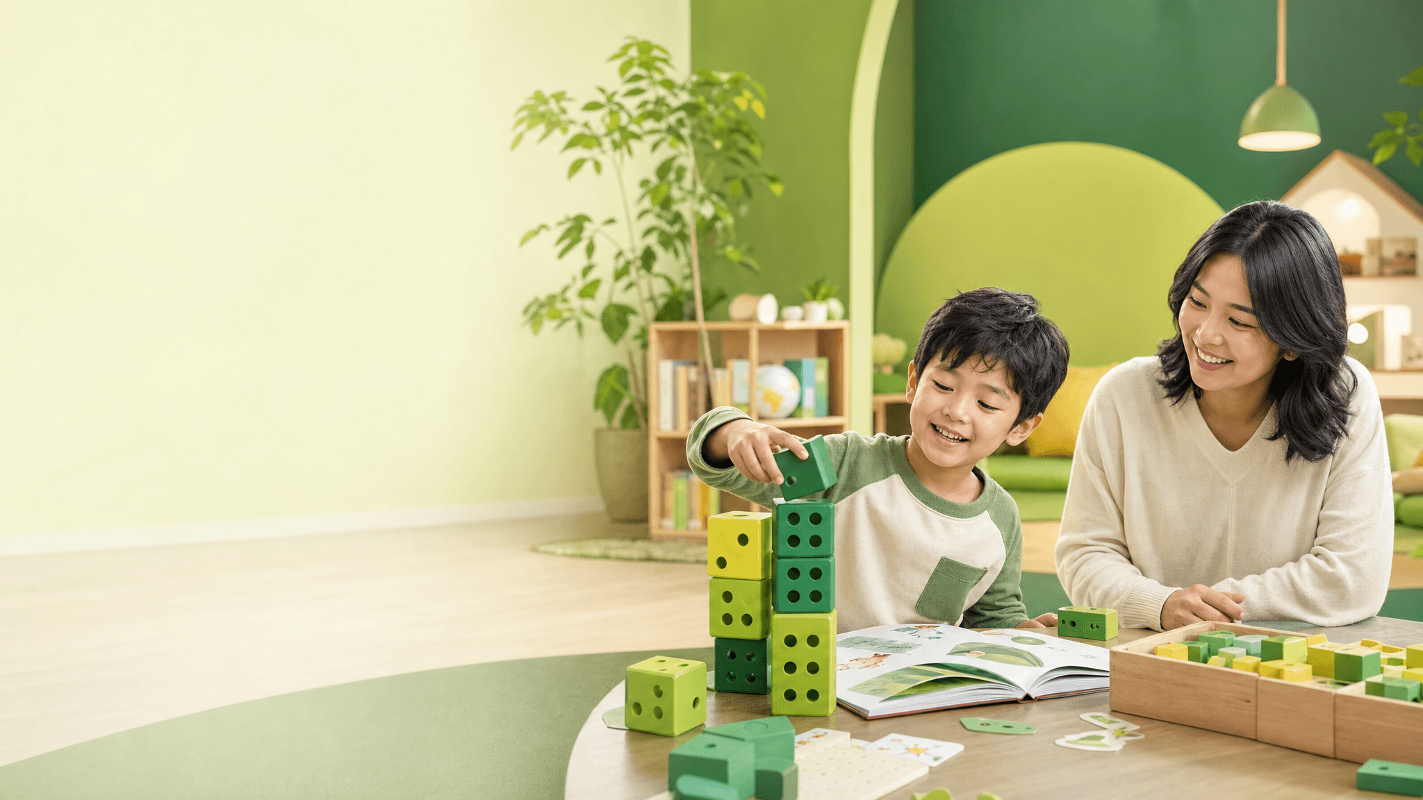 A young learner and parent building with learning blocks in a bright Koydo Junior studio.